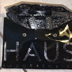 Haus makeup bag with: lip liner and 2 lip gloss